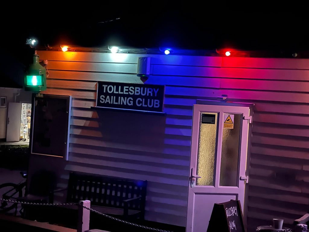 The Tollesbury Sailing Club lit up with coloured lights at night