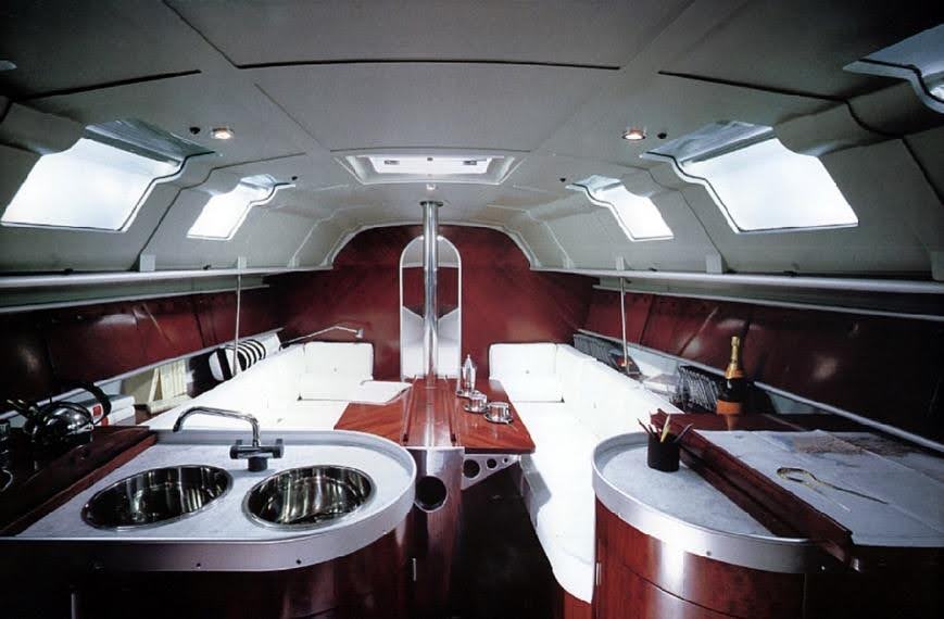 The sleek mahogany and white interior kitchen and dining area of the First 35s5