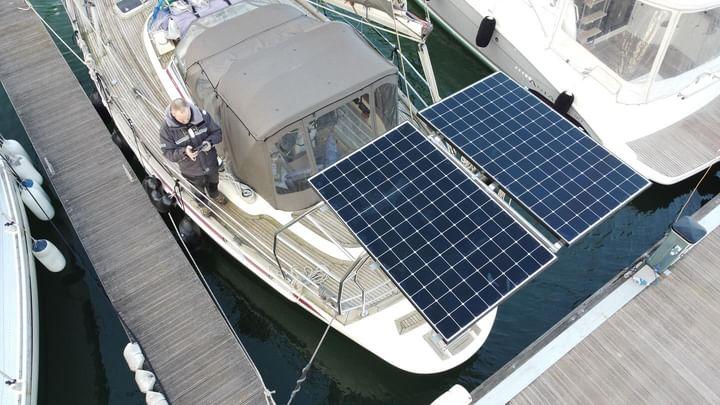 Image of YouTube and Instagram sailors - @followintrepidbear - 's large solid solar panels, installed at an angle to allow water run-off