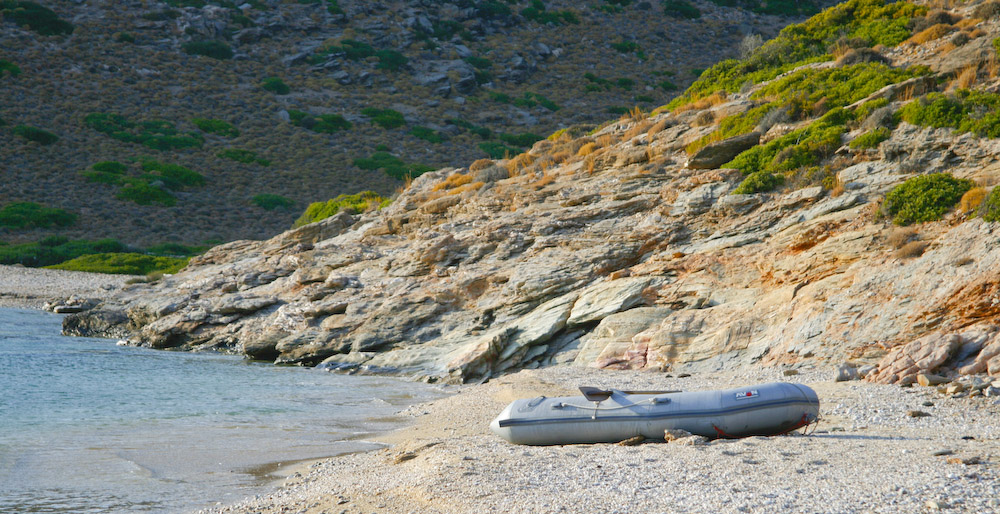Inflatable dinghy on beach with oars
