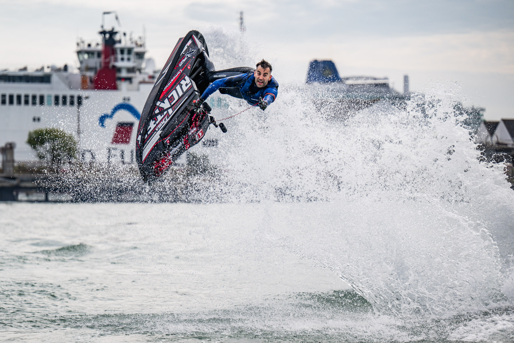 A man does a trick jump on a motorised water toy