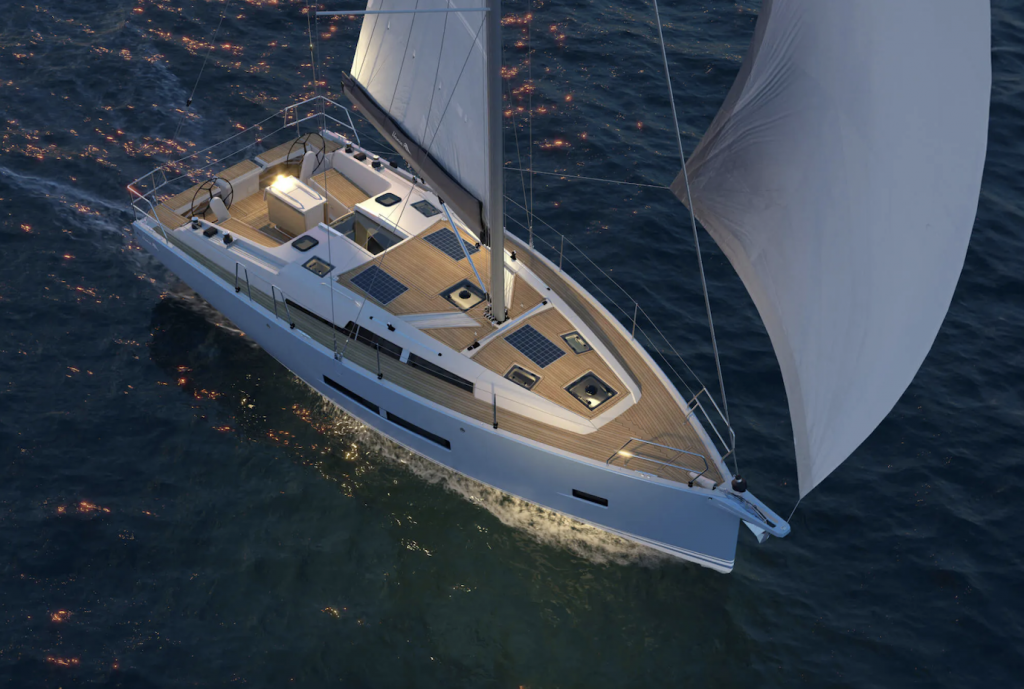 A Hanse 360 sails at twilight with lights on deck