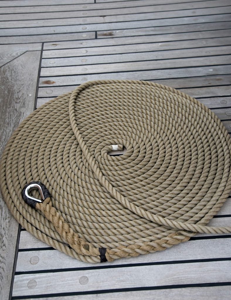 A neatly coiled line sits on the teak deck of the USCG tallship Eagle.