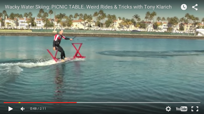 Watch wacky waterskier ride a picnic table
